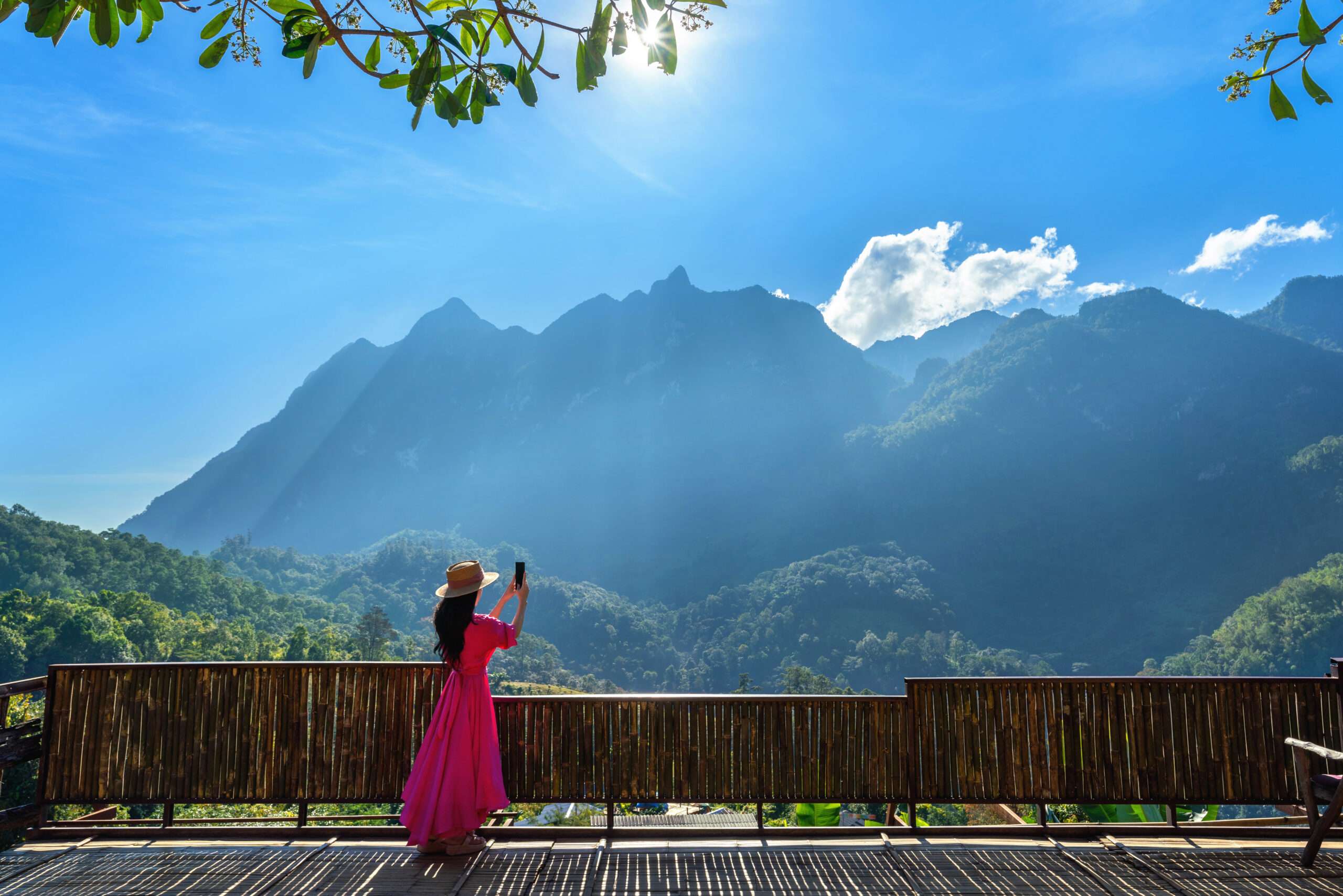 Woman tourist taking photo of Doi Luang Chiang Dao mountains, Chiang mai, Thailand.